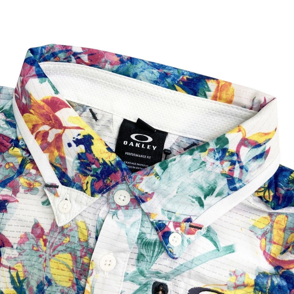 サイズ：L OAKLEY オークリー  半袖ポロシャツ 花柄 ホワイト系 [240101416957] ゴルフウェア メンズ ストスト サイズ：L OAKLEY オークリー 半袖ポロシャツ 花柄 ホワイト系