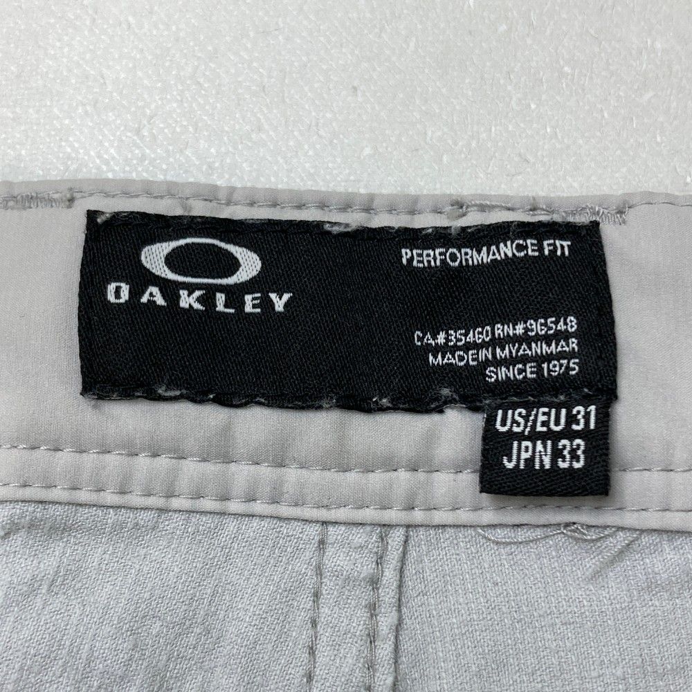 サイズ：33 OAKLEY オークリー FOA404251 ストレッチ パンツ 総柄 ネイビー系 [240101458932] ゴルフウェア メンズ ストスト サイズ：33 OAKLEY オークリー FOA404251 ストレッチ パンツ 総