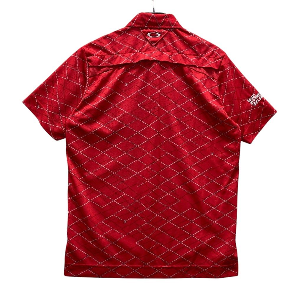 サイズ：XL OAKLEY オークリー  半袖ポロシャツ スカルタグ 総柄 レッド系 [240101474067] ゴルフウェア メンズ ストスト OAKLEY オークリー 半袖ポロシャツ スカルタグ 総柄 レッド系