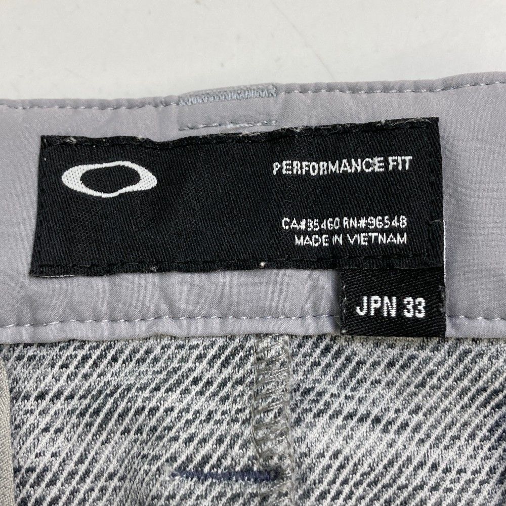 サイズ：33 OAKLEY オークリー ストレッチパンツ 総柄 スカル