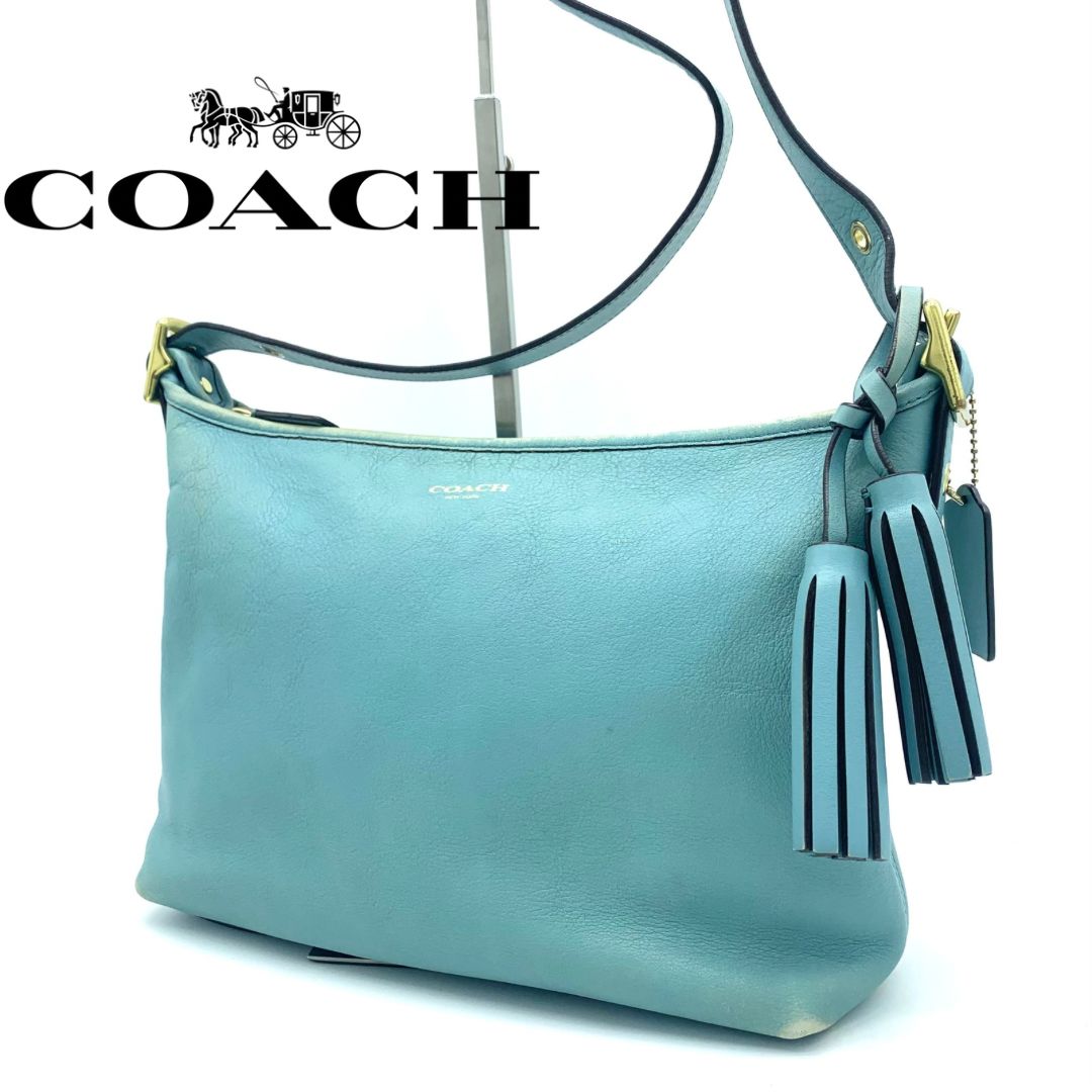 COACH レザー レガシー ショルダーバッグ ボディバッグ ダッフル ショルダー紐調整可能 肩掛け 斜め掛け タッセル付き ライトブルー - メルカリ