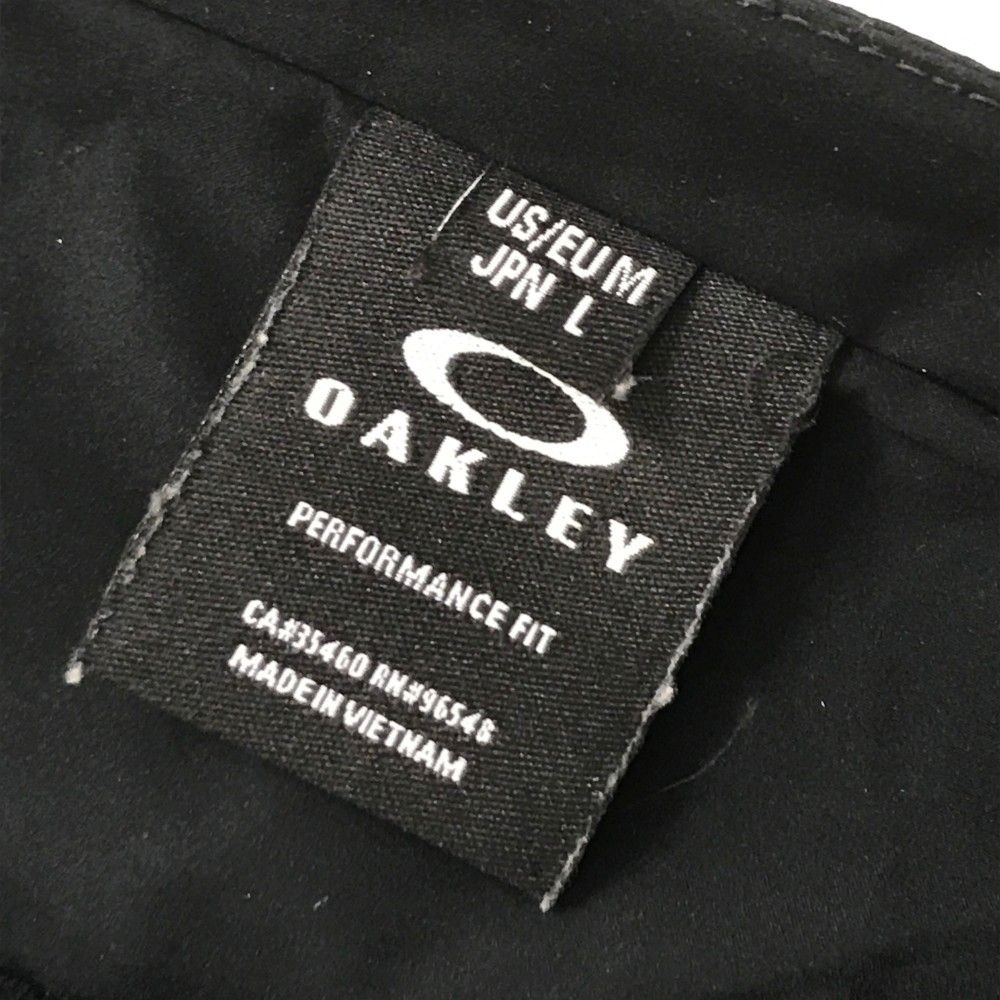 サイズ：L OAKLEY オークリー  ノーカラージャケット  ブラック系 [240101450456] ゴルフウェア メンズ ストスト サイズ：L OAKLEY オークリー ノーカラージャケット ブラック系