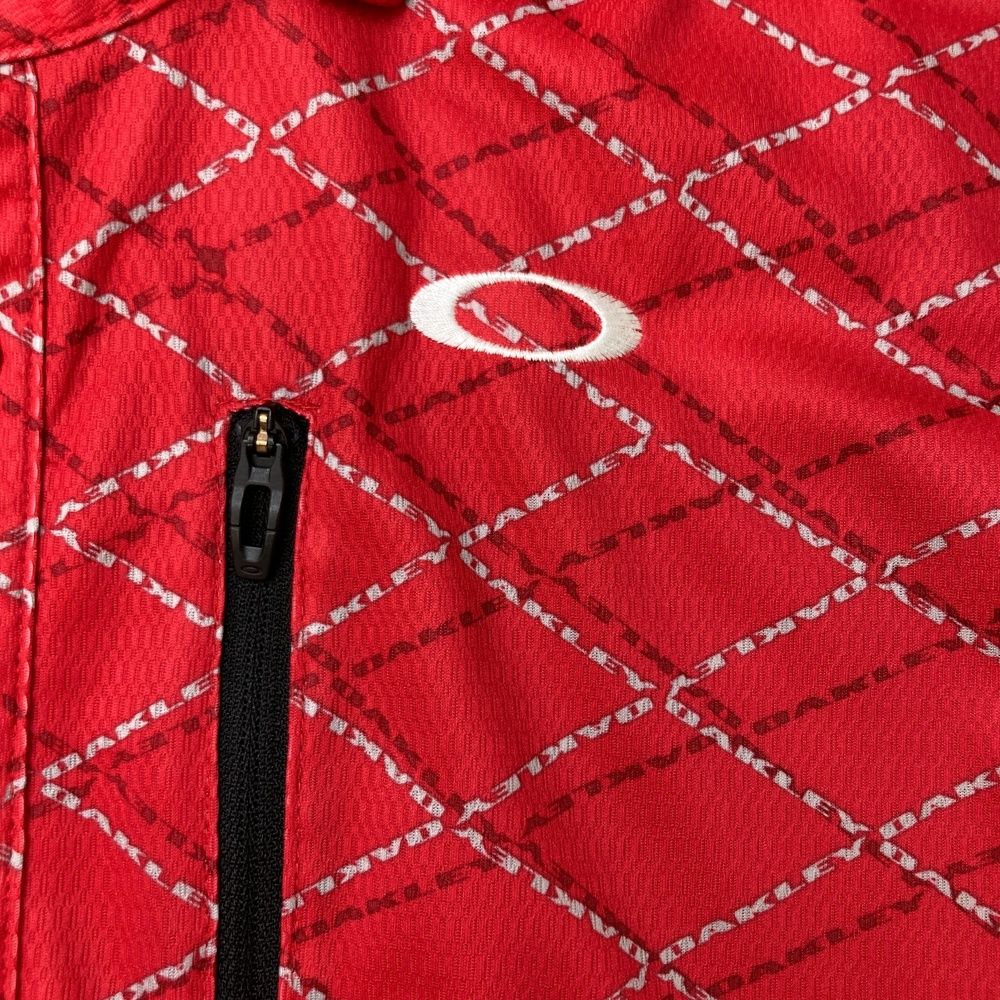 サイズ：XL OAKLEY オークリー  半袖ポロシャツ スカルタグ 総柄 レッド系 [240101474067] ゴルフウェア メンズ ストスト サイズ：XL OAKLEY オークリー 半袖ポロシャツ スカルタグ 総柄