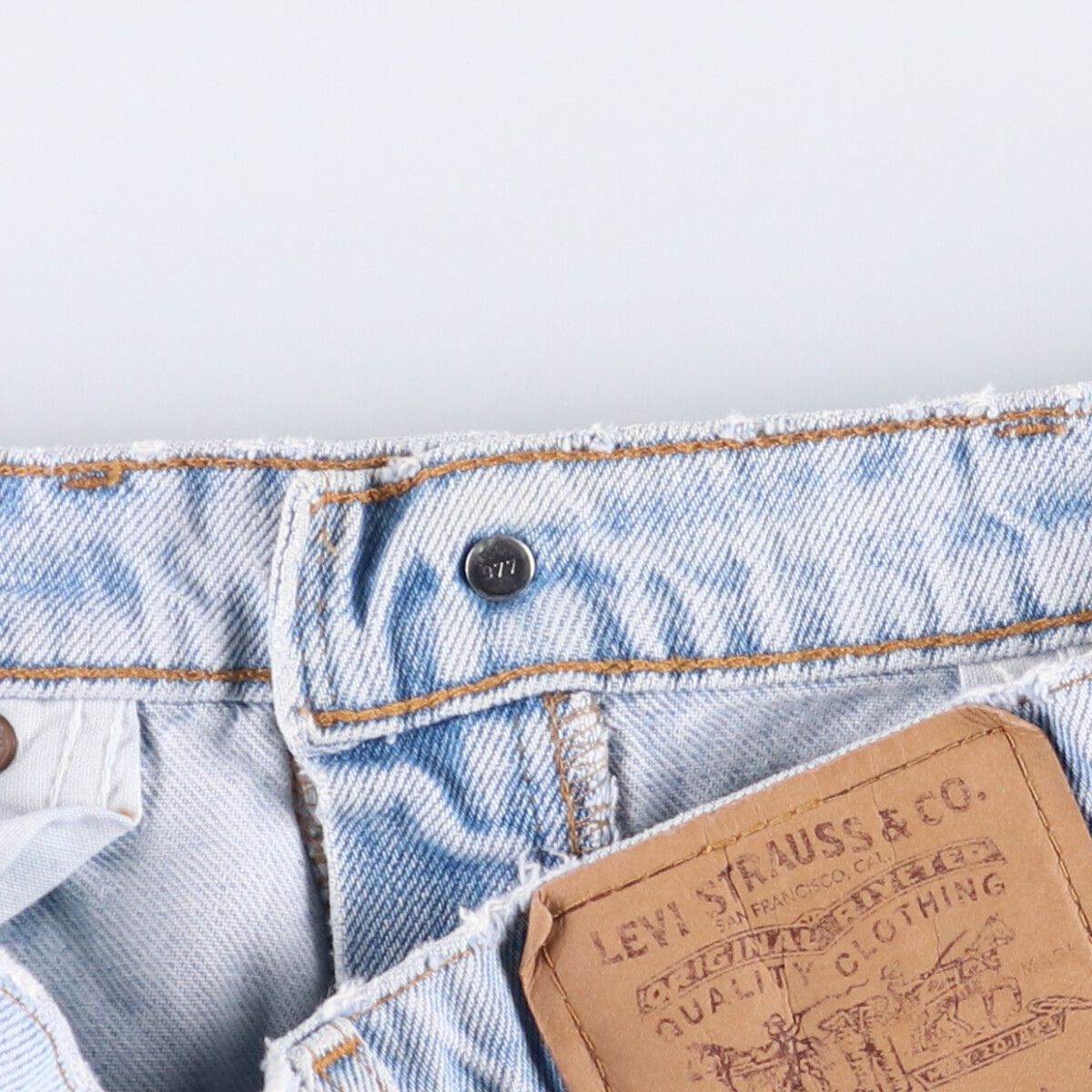 オレンジタブ テーパードデニムパンツ