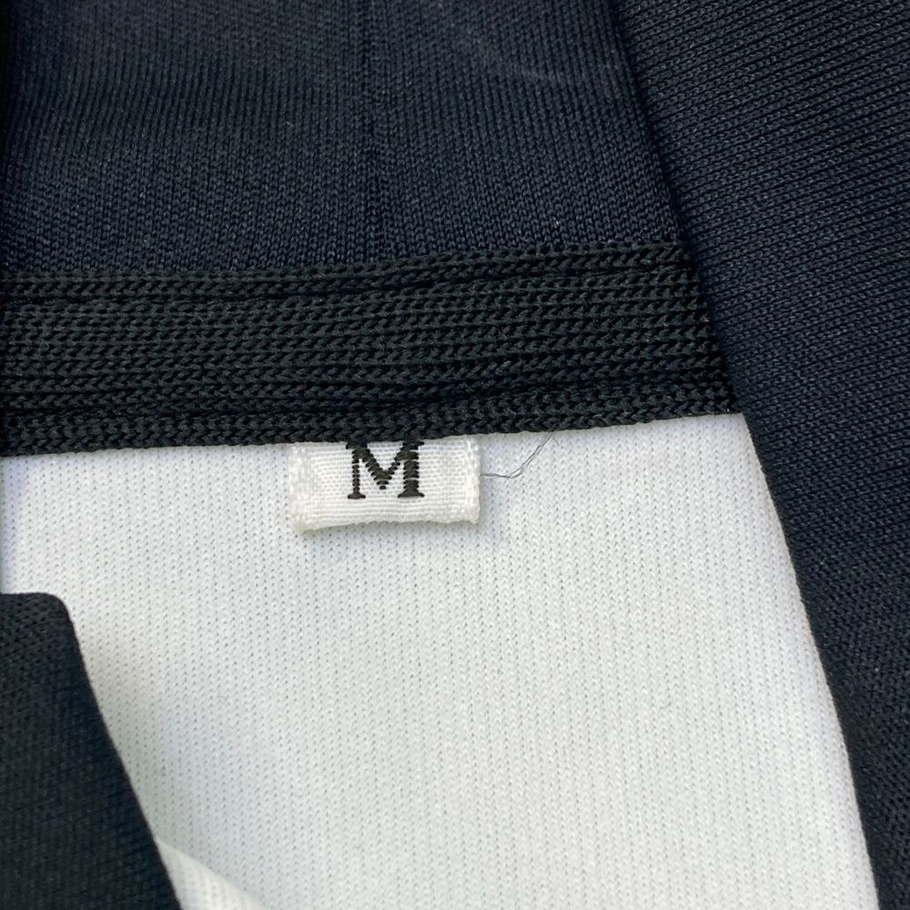 サイズ：M RESURRECTION レザレクション  ハイネック　半袖Tシャツ 総柄 ブラック系 [240101481871] ゴルフウェア レディース ストスト RESURRECTION レザレクション ハイネック 半袖Tシャツ 総柄