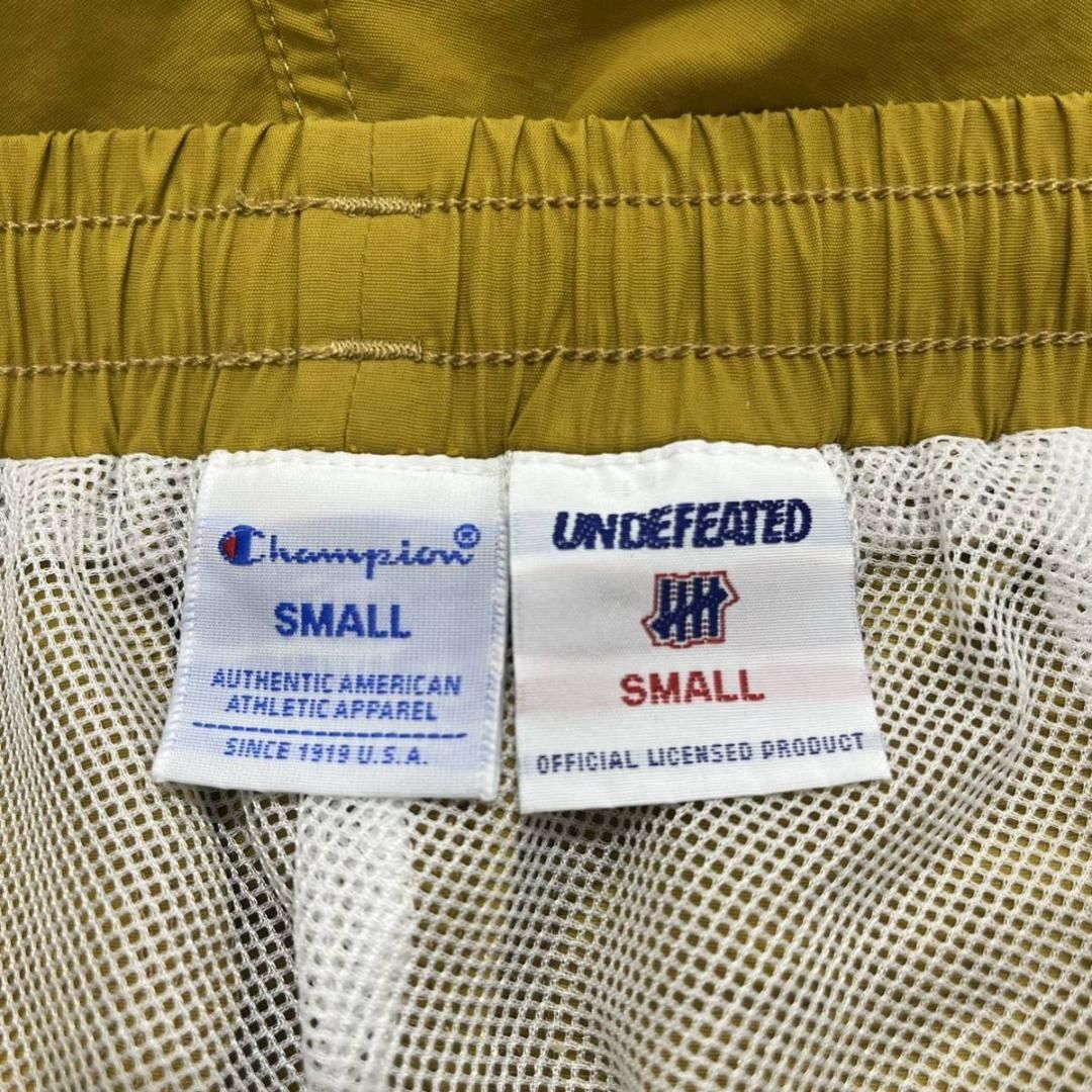 【新品】UNDEFEATED チャンピオン ナイロンパンツl UNDEFEATED アンディフィーテッド × CHAMPION チャンピオン LOGO