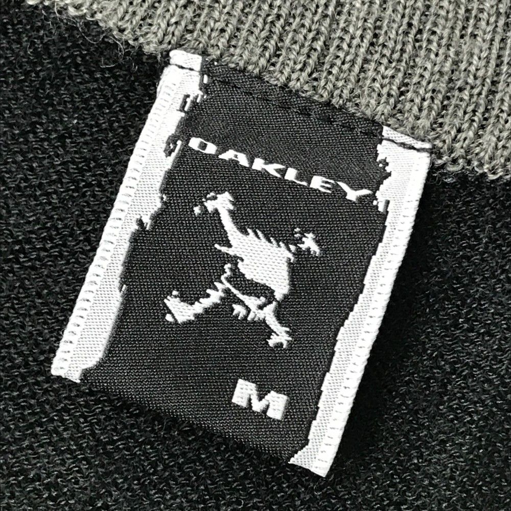 サイズ：M OAKLEY オークリー 433200JP ニット セーター スカル 総柄 ブラック系 [240101439804] ゴルフウェア メンズ ストスト サイズ：M OAKLEY オークリー 433200JP ニット セーター スカル
