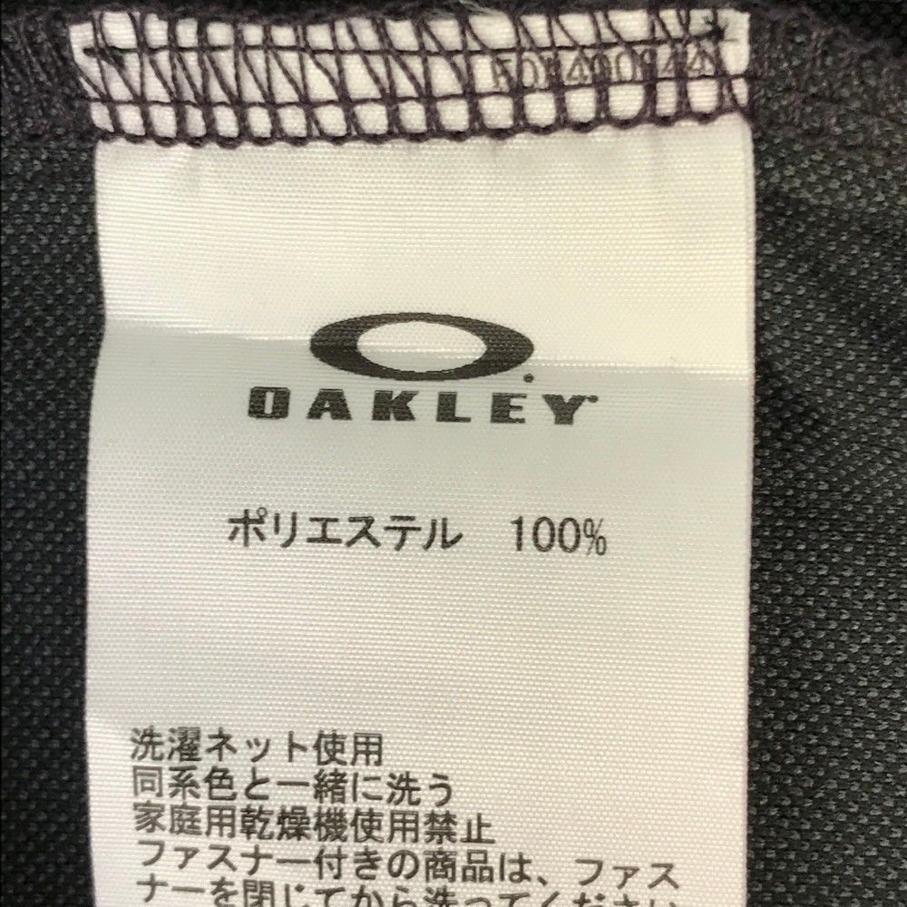 サイズ：XL OAKLEY オークリー FOA400844 半袖ポロシャツ ロゴプリント 総柄 ブラック系 [240101472864] ゴルフウェア メンズ ストスト サイズ：XL OAKLEY オークリー FOA400844 半袖ポロシャツ ロゴ