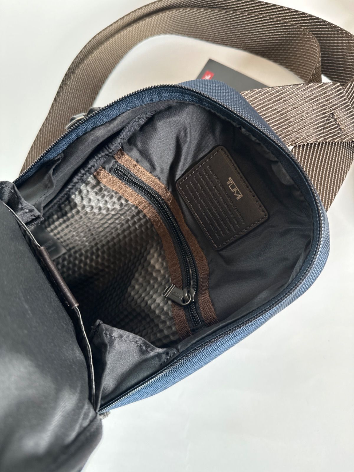 Tumi fife slim online sling bag