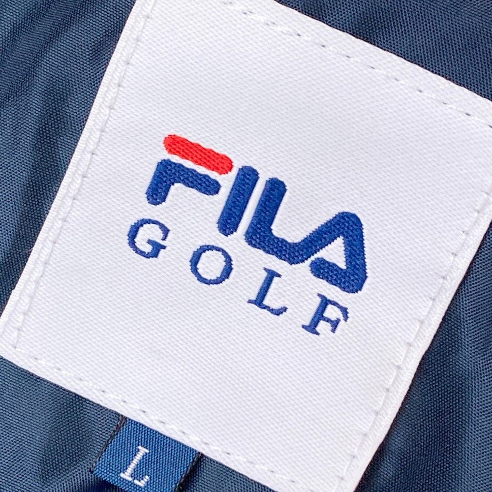 サイズ：M FILA GOLF フィラゴルフ  中綿 ジップジャケット 総柄 ネイビー系 [240101453857] ゴルフウェア メンズ ストスト サイズ：M FILA GOLF フィラゴルフ 中綿 ジップジャケット 総柄
