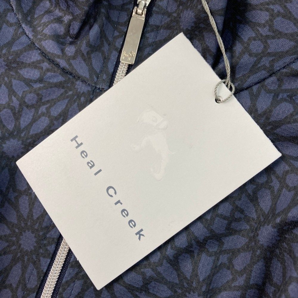 サイズ：42 HEAL CREEK ヒールクリーク  長袖ハーフジップTシャツ 総柄 ネイビー系 [240101449138] ゴルフウェア レディース ストスト サイズ：42 HEAL CREEK ヒールクリーク 長袖ハーフジップTシャツ