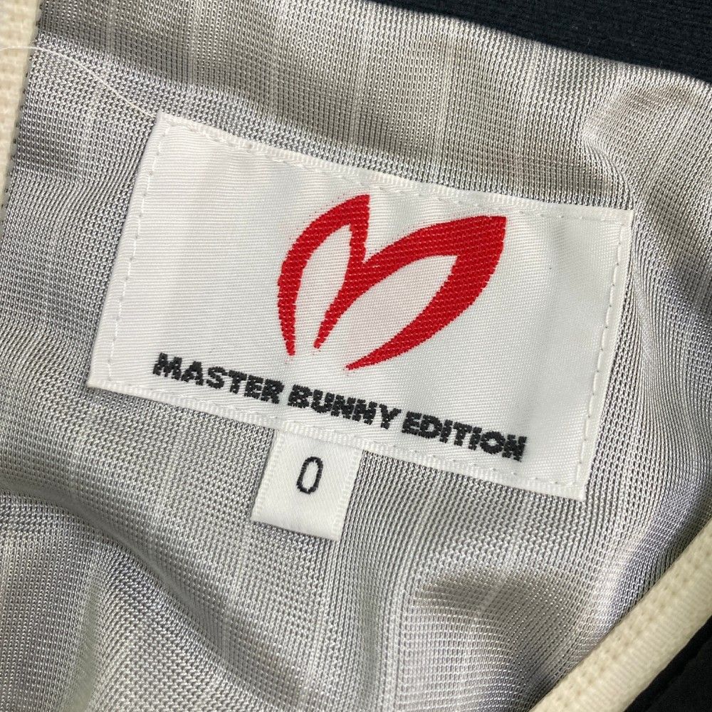 サイズ：0 MASTER BUNNY EDITION マスターバニーエディション 10周年 蓄熱 ジップジャケット ロゴ総柄 ブラック系 [240101409035] ゴルフウェア レディース ストスト サイズ：0 MASTER BUNNY EDITION マスターバニーエディション 10