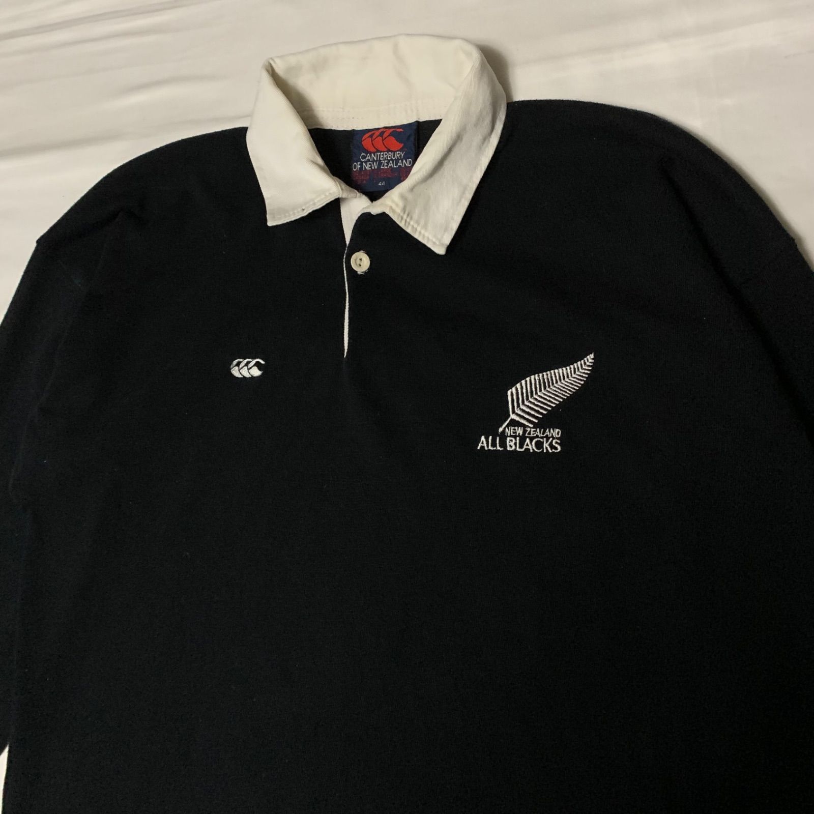 90-00s CANTERBURY “NZ ALL BLACKS” L/S Rugby Shirt カンターベリー ニュージーランド オールブラックス  ラガーシャツ 長袖 ブラック ホワイト ロゴ刺繍 ラバーボタン ラグビー ナショナルチーム