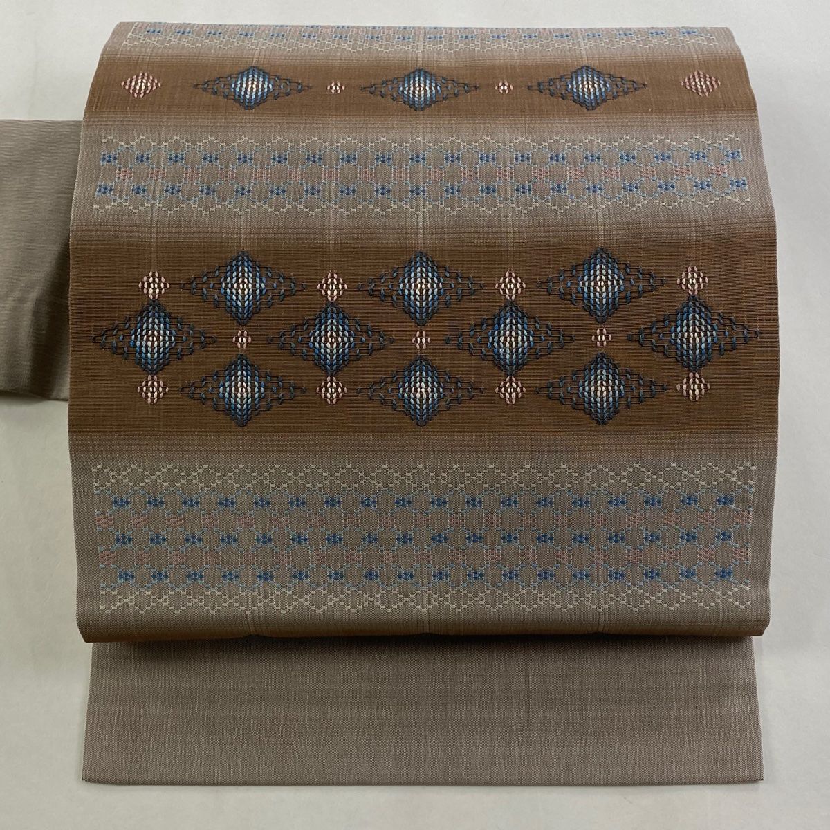 名古屋帯 紬地 菱 幾何学模様 薄小豆 正絹