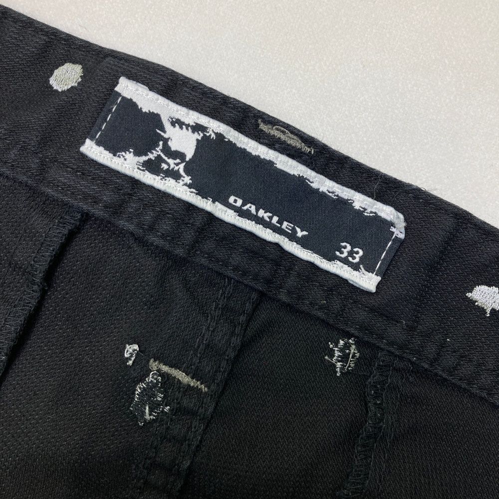 サイズ：33 OAKLEY オークリー ロングパンツ 刺繍柄 ブラック系