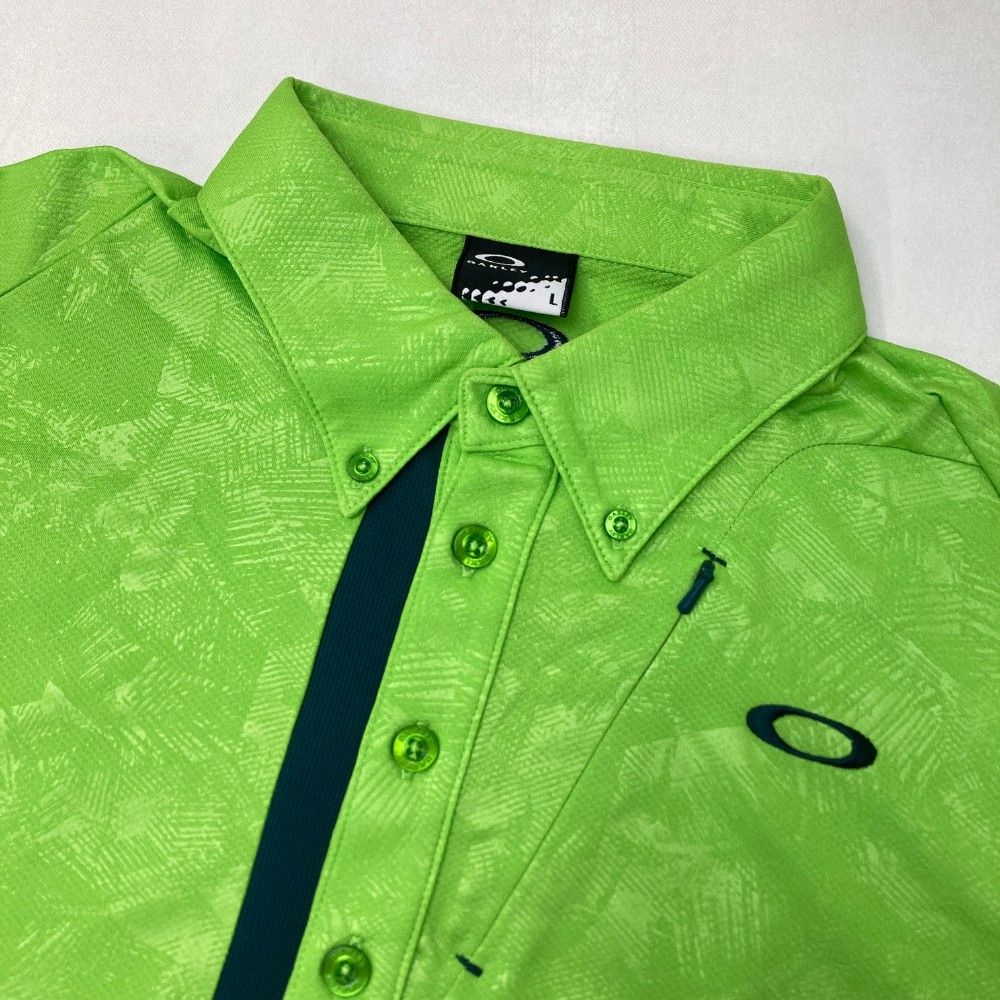 サイズ：L OAKLEY オークリー 434390JP 半袖ポロシャツ ボタンダウン 総柄 グリーン系 [240101494240] ゴルフウェア メンズ ストスト OAKLEY オークリー 434390JP 半袖ポロシャツ ボタンダウン 総柄