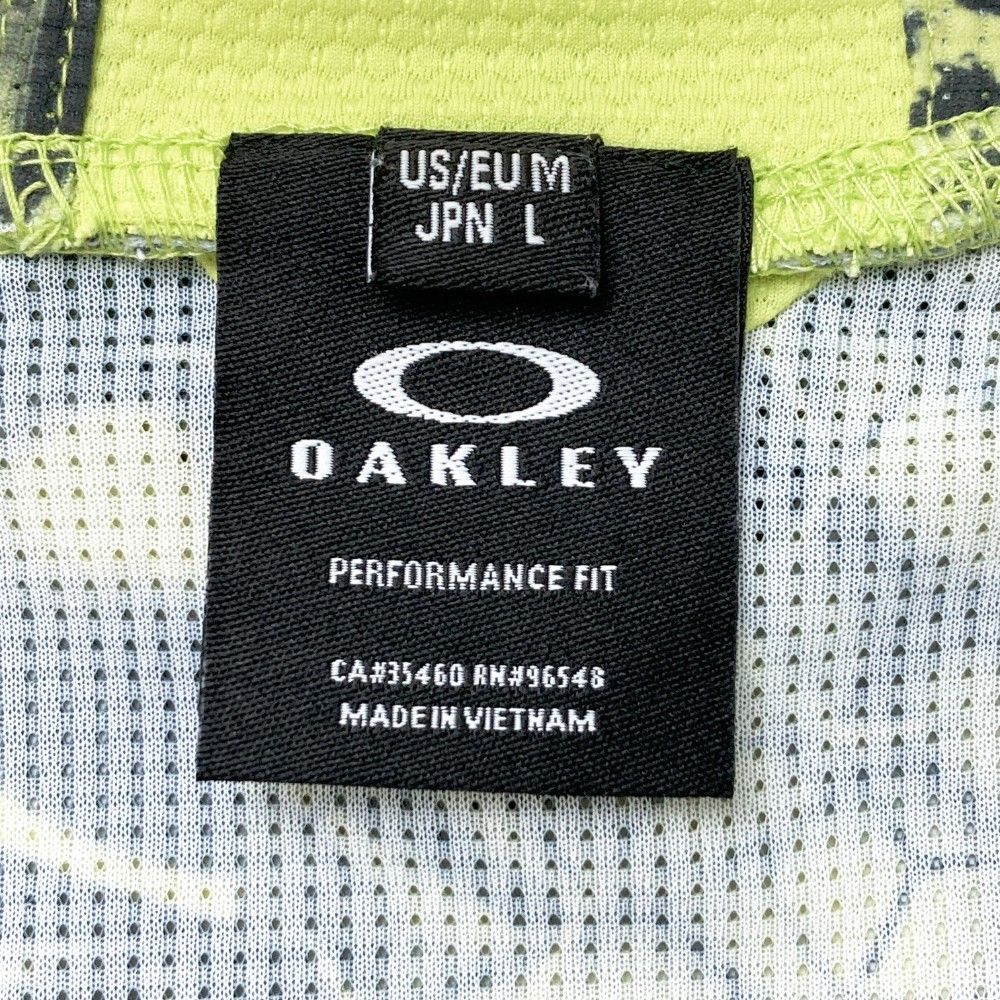 サイズ：L OAKLEY オークリー 2023年モデル ハイネック半袖Tシャツ スカル 総柄 グリーン系 [240101214720] ゴルフウェア メンズ ストスト サイズ：L OAKLEY オークリー 2023年モデル ハイネック半袖T