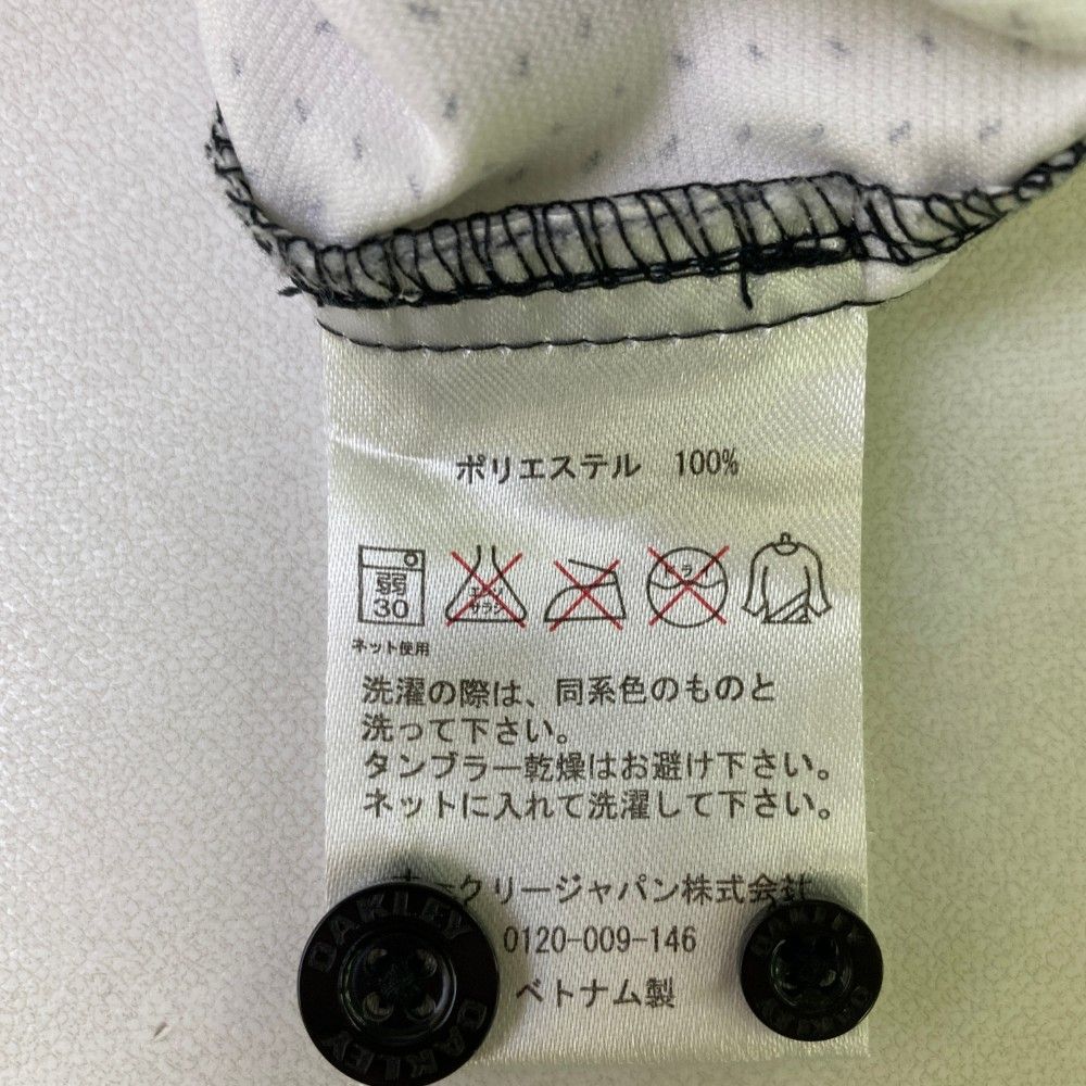 サイズ：XL OAKLEY オークリー 401820JP 長袖シャツ ボタンダウン スカル刺繍 総柄 ブラック系 [240101472882] ゴルフウェア メンズ ストスト サイズ：XL OAKLEY オークリー 401820JP 長袖シャツ ボタン