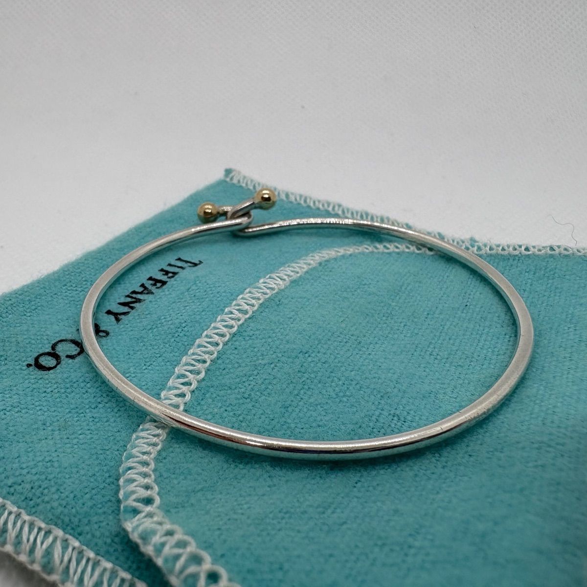 ティファニー フック＆アイ ラブノットバングル K18コンビ