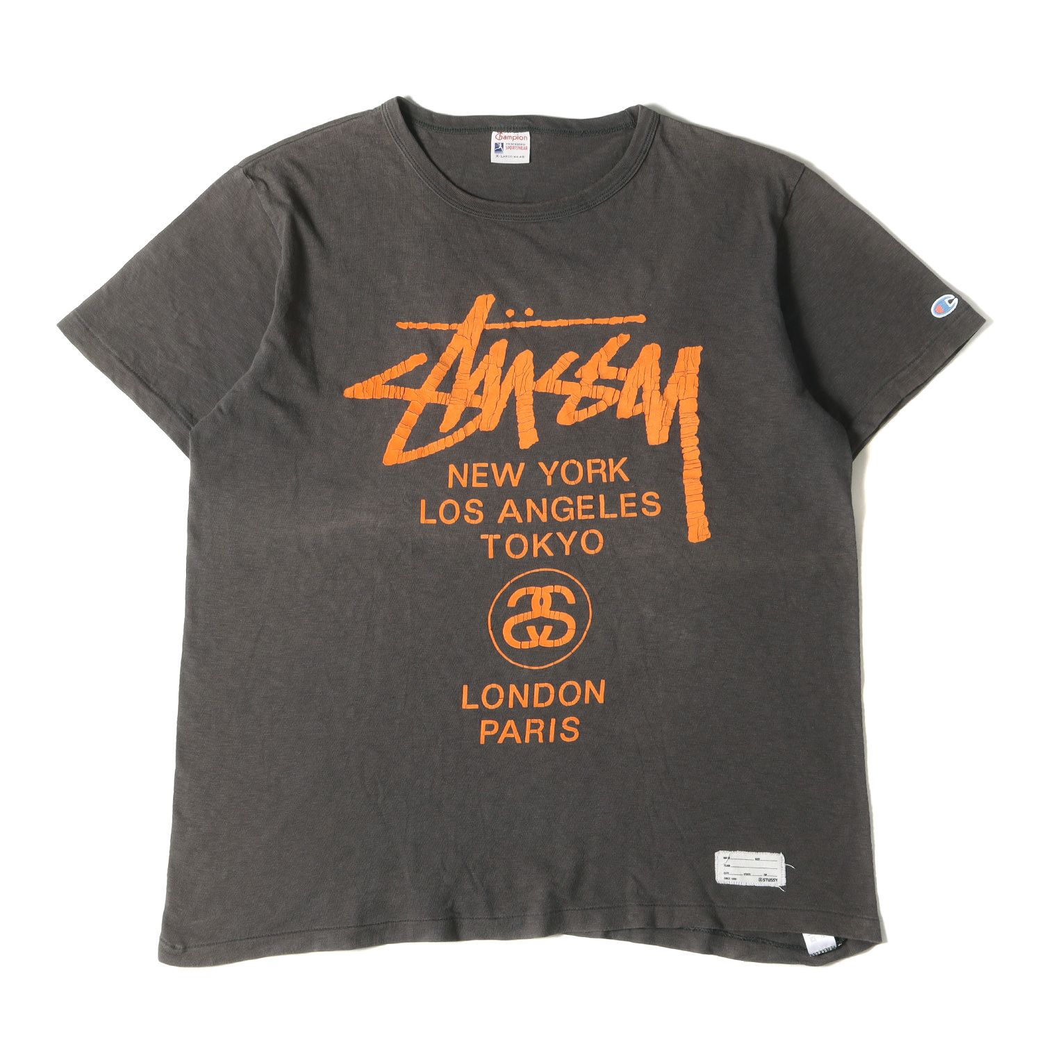STUSSY ステューシー Tシャツ サイズ:XL Champion フロッキープリント ワールドツアー クルーネック 半袖Tシャツ チャコール トップス カットソー コラボ【メンズ】