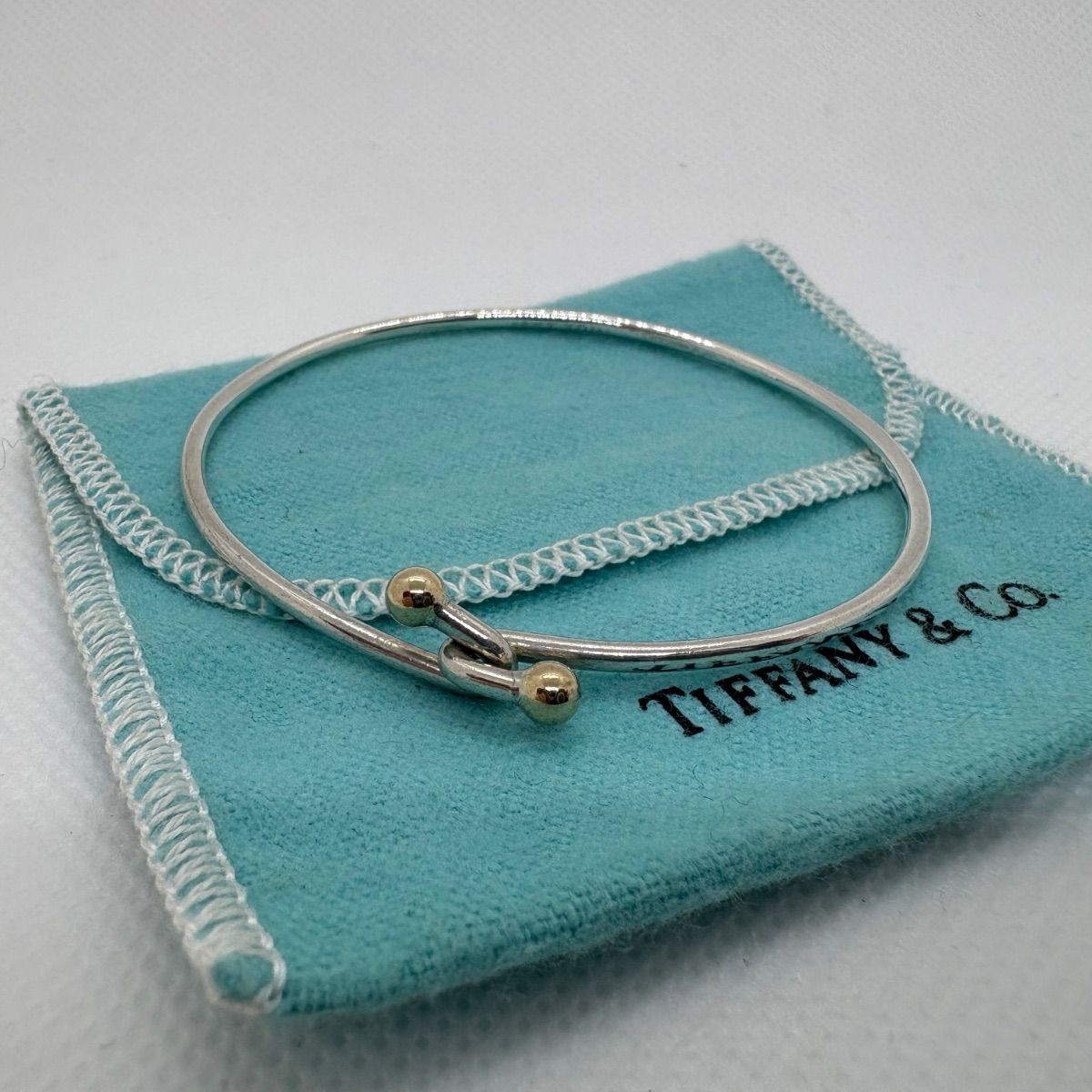 ティファニー フック＆アイ ラブノットバングル K18コンビ
