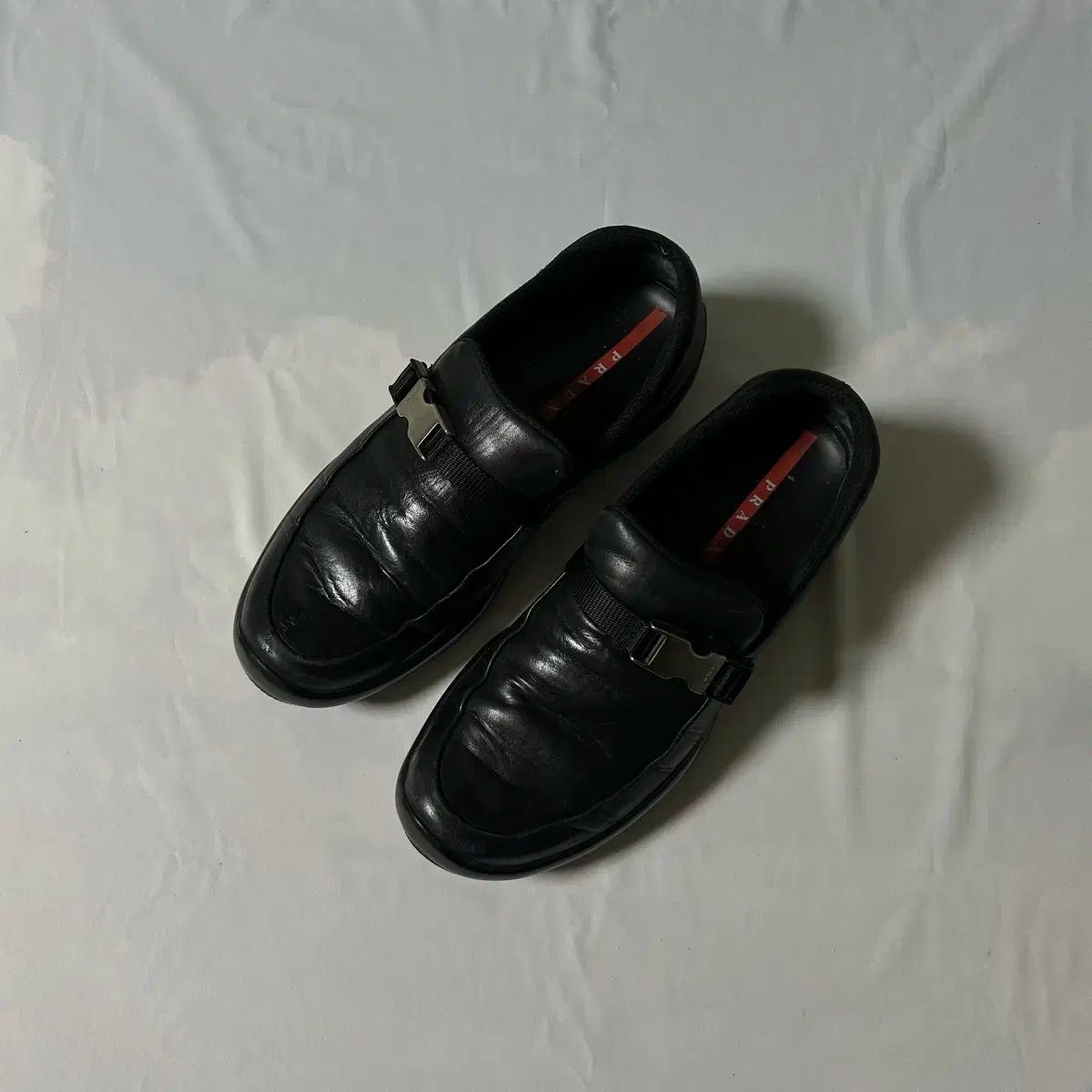 Prada sports buckle strap loafers
