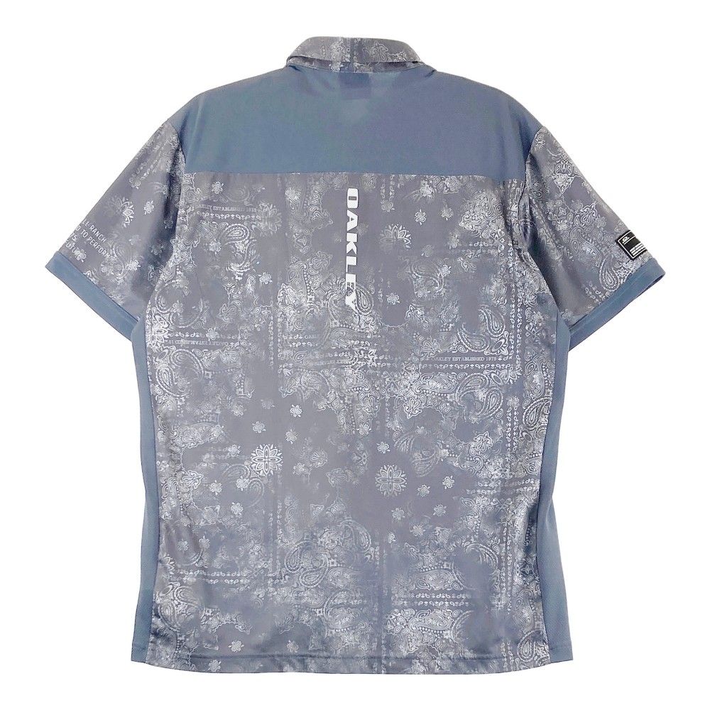 サイズ：XL OAKLEY オークリー FOA406771 2024年モデル 半袖ポロシャツ ペイズリー 総柄 グレー系 [240101459734] ゴルフウェア メンズ ストスト OAKLEY オークリー FOA406771 2024年モデル 半袖ポロシャツ