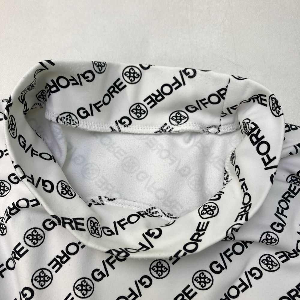 サイズ：2 G/FORE ジーフォア  ハイネック 長袖Tシャツ ロゴ総柄 ホワイト系 [240101468807] ゴルフウェア メンズ ストスト サイズ：2 G/FORE ジーフォア ハイネック 長袖Tシャツ ロゴ総柄