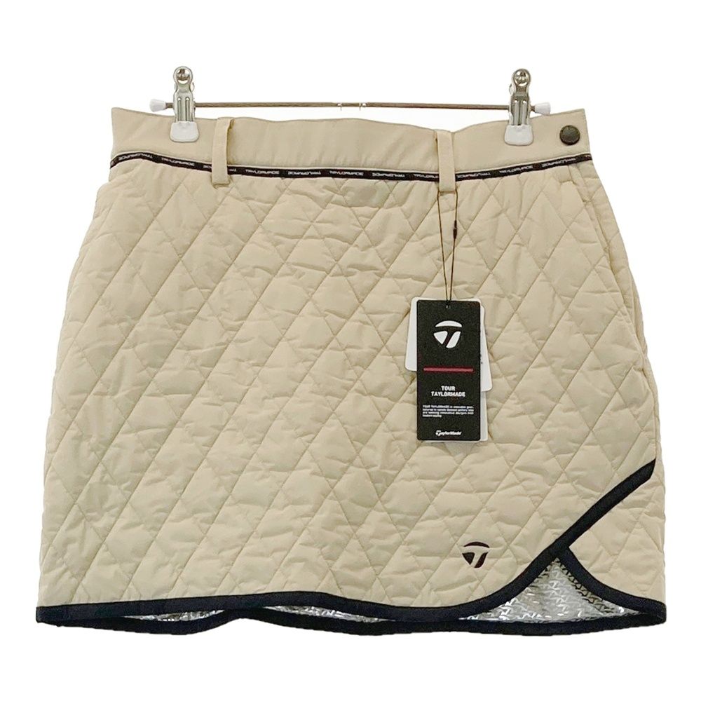 サイズ M TAYLOR MADE テーラーメイド 2025年モデル インナー付中綿スカート ベージュ系 240101527467 ゴルフウェア レディース ストスト