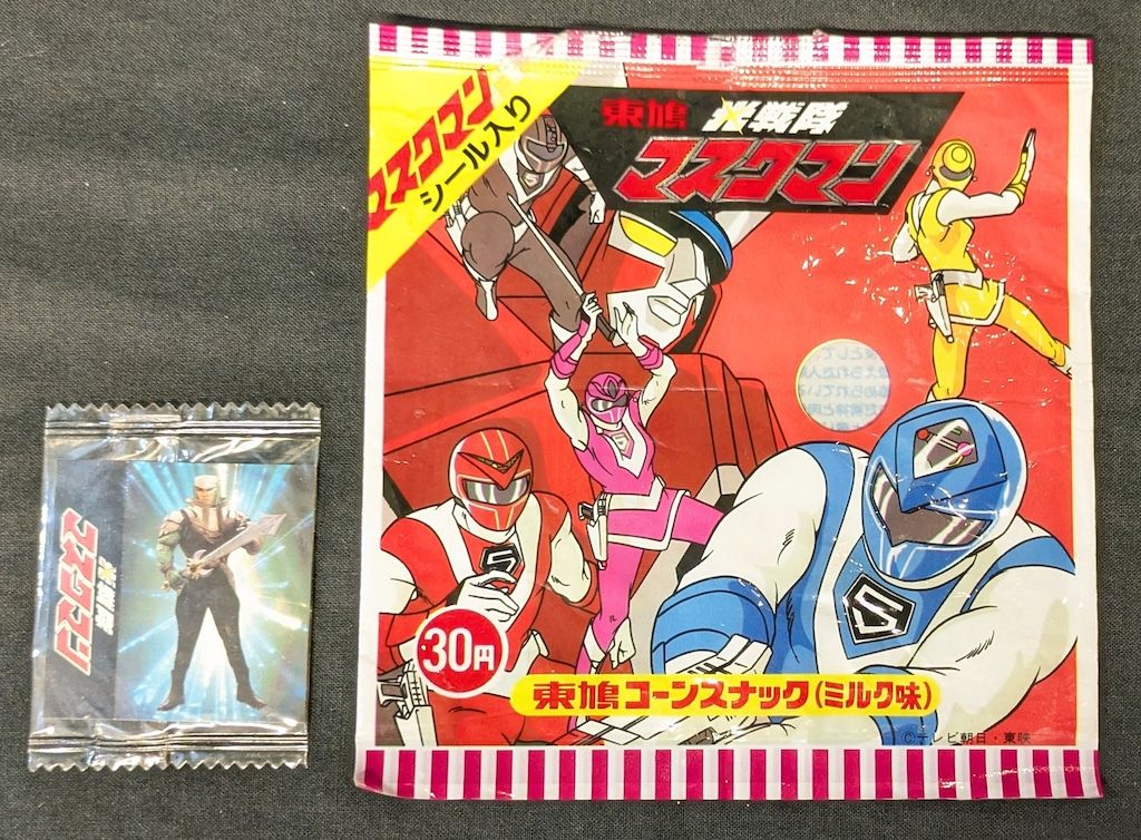 東鳩 菓子パッケージ|マスクマンコーンスナック 左下銃構えたブルー 左上にイエロー ミルク味