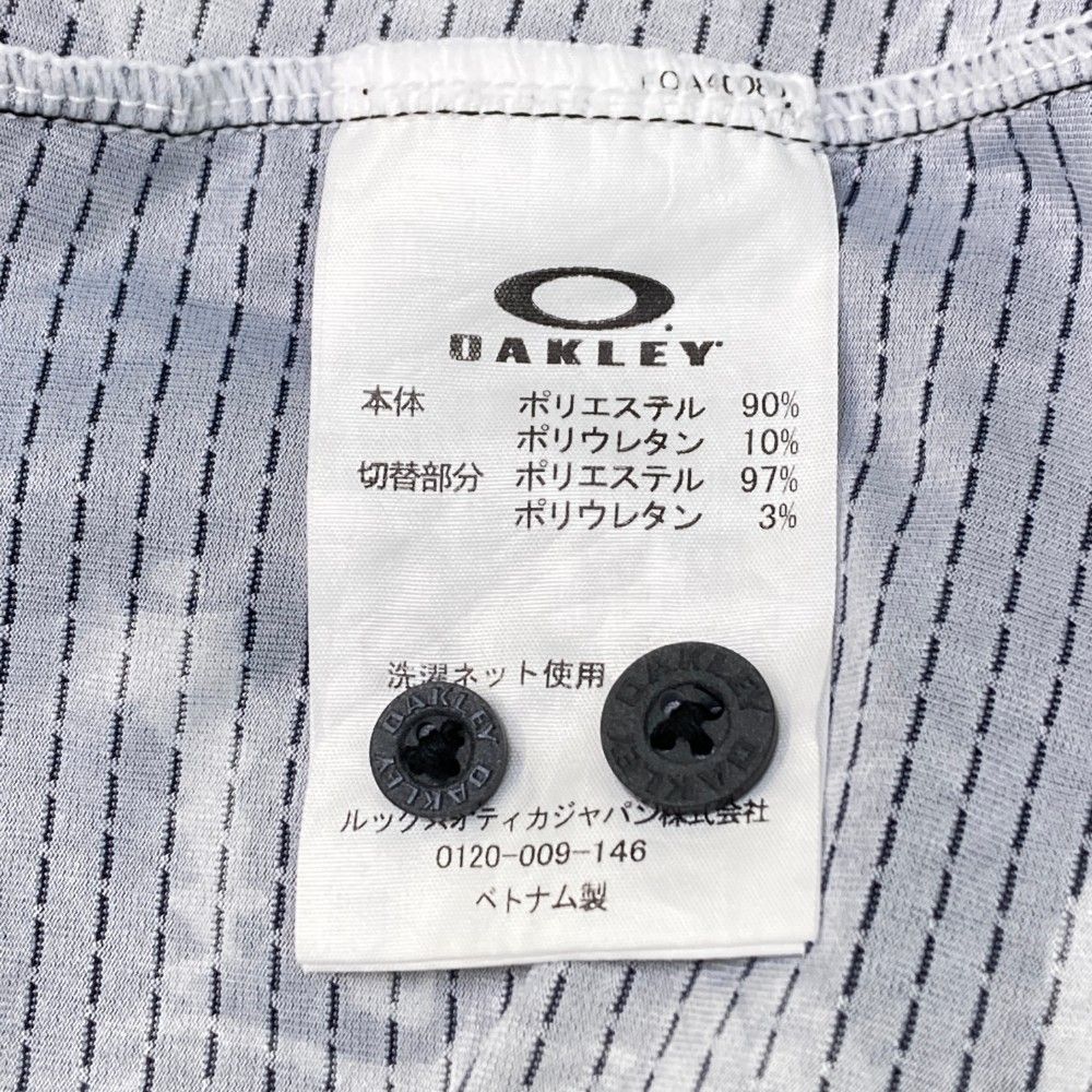 サイズ：XL OAKLEY オークリー  半袖ポロシャツ 総柄 ブラック系 [240101448099] ゴルフウェア メンズ ストスト サイズ：XL OAKLEY オークリー 半袖ポロシャツ 総柄 ブラック系