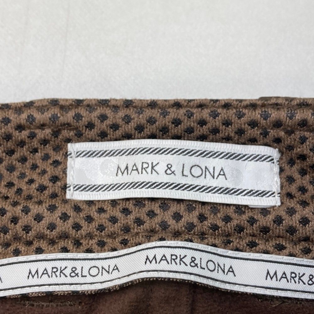 サイズ：L MARK&LONA マークアンドロナ  ロングパンツ 星 スカル 総柄 ブラウン系 [240101473146] ゴルフウェア メンズ ストスト サイズ：L MARK&LONA マークアンドロナ ロングパンツ 星 スカル