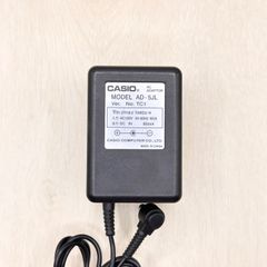 AD-5JL CASIO Genuine AC Adapter for Electronic Keyboards, Pianos, and Keyboard Instruments (Compatible with CPS-10L, WK-210, LK-90TV, CTK-671). Output: 9V 0.85A. Plug Outer Diameter: Approx. 5.5mm. Center Negative. Part Number: 60-80309-382