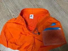 ナイキ オレンジ色 メッシュ ポケット ハーフパンツ (レディース)