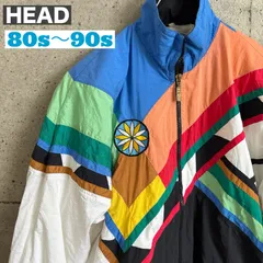 【US古着】90s HEAD ナイロンジャケット クレイジーパターン マルチカラー 幾何学柄 L相当 レトロ かわいい スポーツミックス ヴィンテージ テニス ウインドブレーカー 切替 刺繍ロゴ 派手 個性的 ストリート オールドヘッド 肩パッドのサムネイル