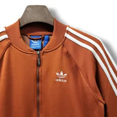 100 adidas(アディダス) オレンジキャラメル&ホワイトライン スーパースター ジャージ