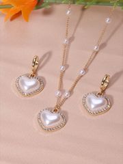 Women's Jewelry Set: Heart-shaped faux pearl necklace & earrings with shiny rhinestone embellishments. Elegant jewelry set perfect for Valentine's Day.