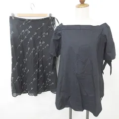 カージュ Khaju コムサイズム COMME CA ISM ブラウス スカート 2枚セット 半袖 オフショルダー リボン ひざ下丈 フレア 花柄 綿 紺 黒 ネイビー ブラック Sのサムネイル