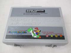 Discounted Super Famicom console (SHVC-001) with peripherals and Super Mario World storage case.