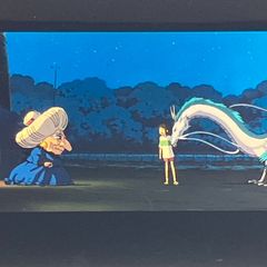 Film reel of "Spirited Away" (35mm), Studio Ghibli, featuring "Yubaba, Chihiro, and Haku the Dragon," framed, Hayao Miyazaki, clear block, released in 2001 (FLM038)