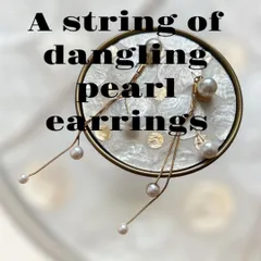 A string of dangling pearl earrings