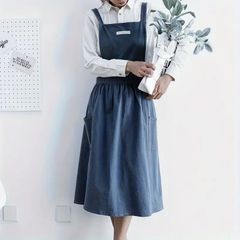 Cute Japanese vintage-style apron dress in indigo blue with cross-back straps and dual pockets. Women's cotton weaver's apron for cooking, painting, gardening, etc. Made of 100% cotton.