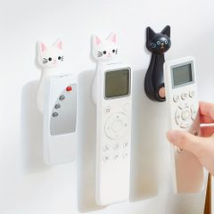 リモコン用の3つの創造的なマグネットフック。壁に取り付けられる強力な接着剤を備え、かわいい猫の漫画がデザインされており、テレビやエアコンのリモコンを跡を残さずに整理するのに最適です。プロジェクターにも適しています。