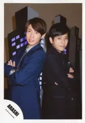 【中古】生写真(ジャニーズ) 嵐/相葉雅紀・二宮和也/膝上・ジャケット青・黒・背中合わせ・腕組み・背景ビルのオブジェ/「復活LOVE」PV＆ジャケ写撮影オフショット/公式生写真