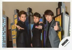 【中古】生写真(ジャニーズ) 嵐/集合(3人)/横型・膝上・ジャケット黒グレー・センター大野・指差し・松本右手パー・櫻井左手親指立て・背景ビルのオブジェ/「復活LOVE」PV＆ジャケ写撮影オフショット/公式生写真